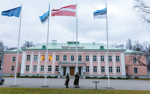 The Latvian flag flanked by those of Estonia in front of the Presidential Palace in Kadriorg, Tallinn.